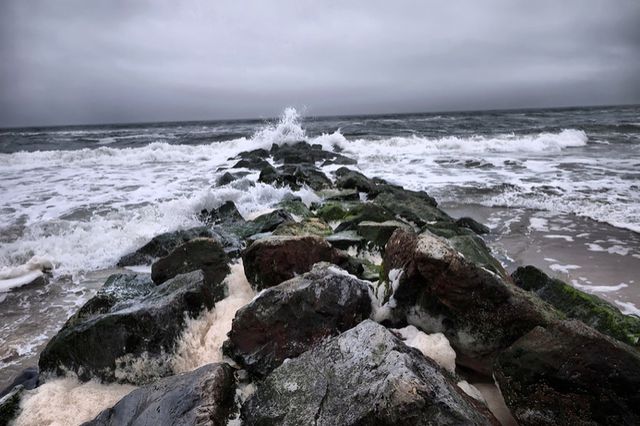 This is a photo of waves crashing on a rock jetty at Rockaway Beach.